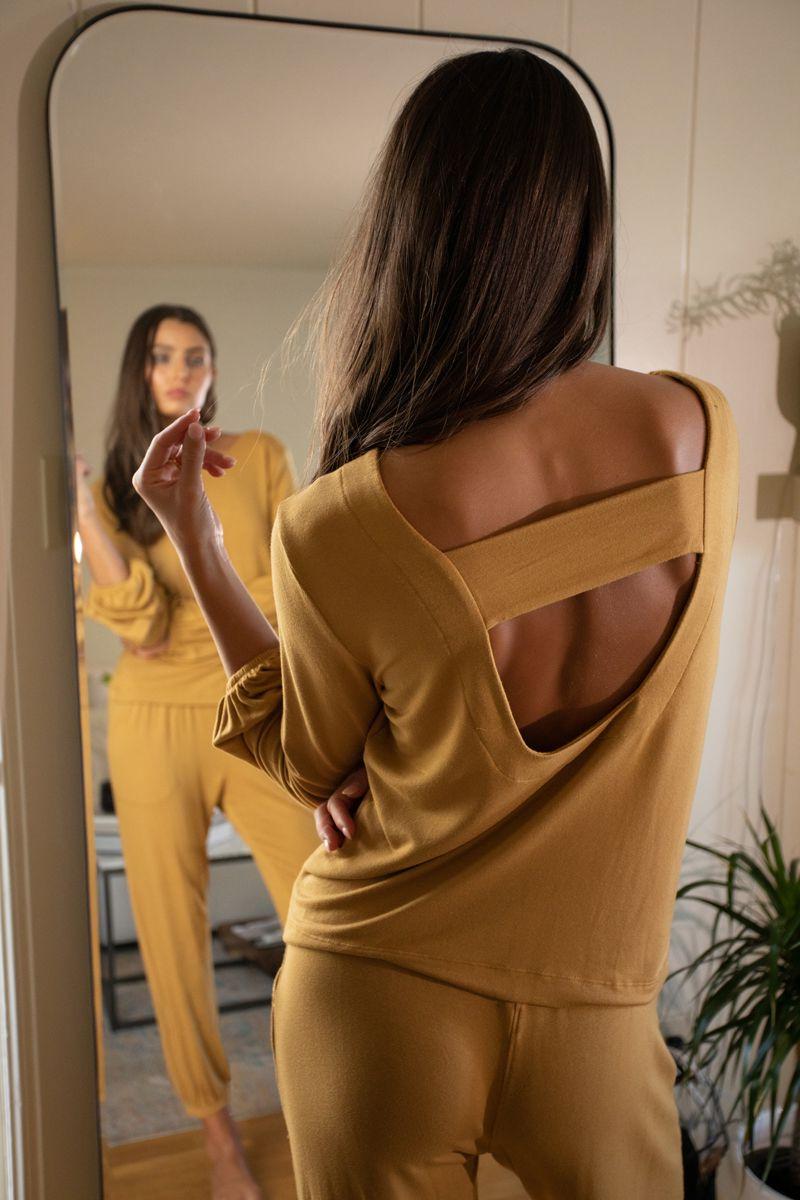 model looking in mirror in camel colored matching lounge set of pants and long sleeve